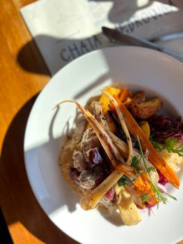 Delicious gourmet dish with roasted vegetables and meat, perfect for a restaurant setting.