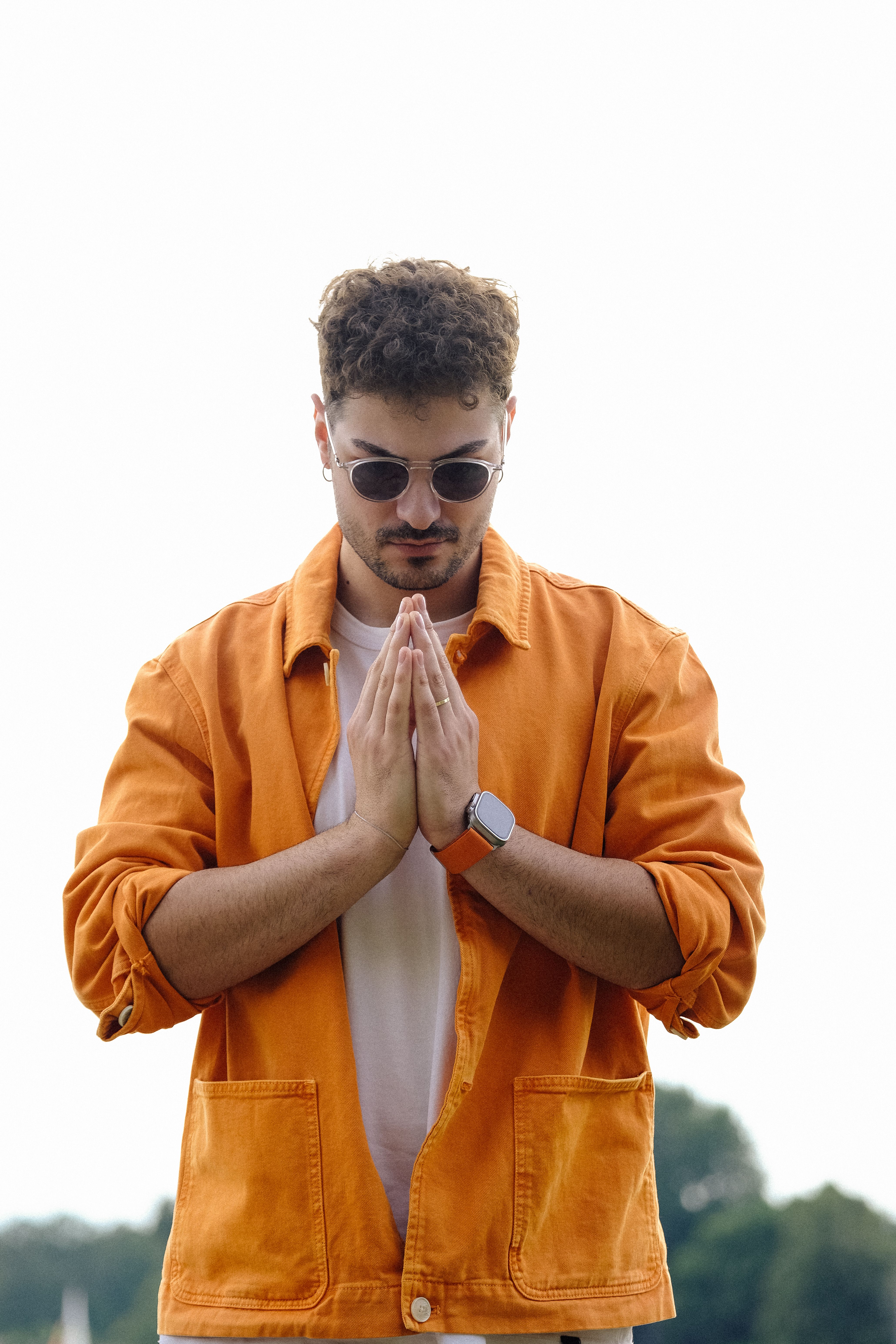 Man in Sunglasses and Orange Shirt Standing with Hands Clasped · Free ...