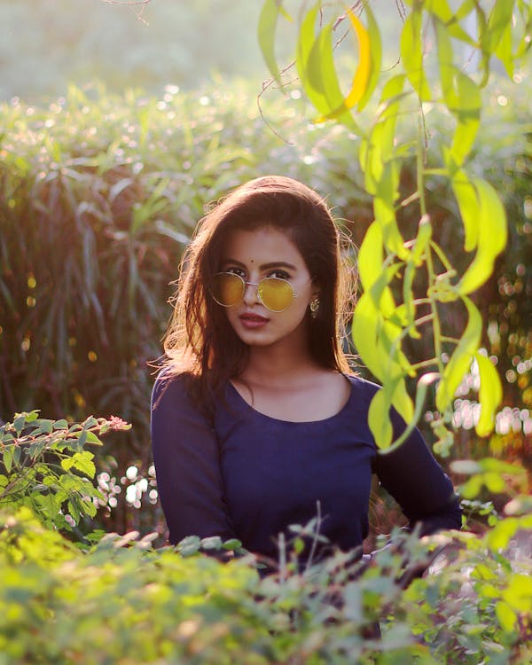 Woman Standing Behind Leaves