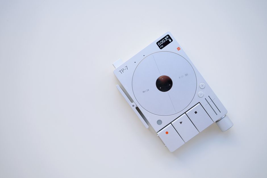 Minimalist photo of TP-7 tape recorder on a white background, showcasing retro technology.