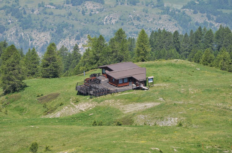 Wooden House On Hill In Mountains