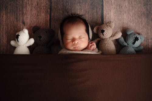 Free Baby Sleeping with Teddy Bears Stock Photo