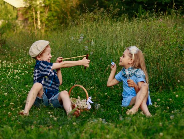 Children blowing bubbles together on a sunny meadow. Photo by Ирина Сороколетова on Pexels