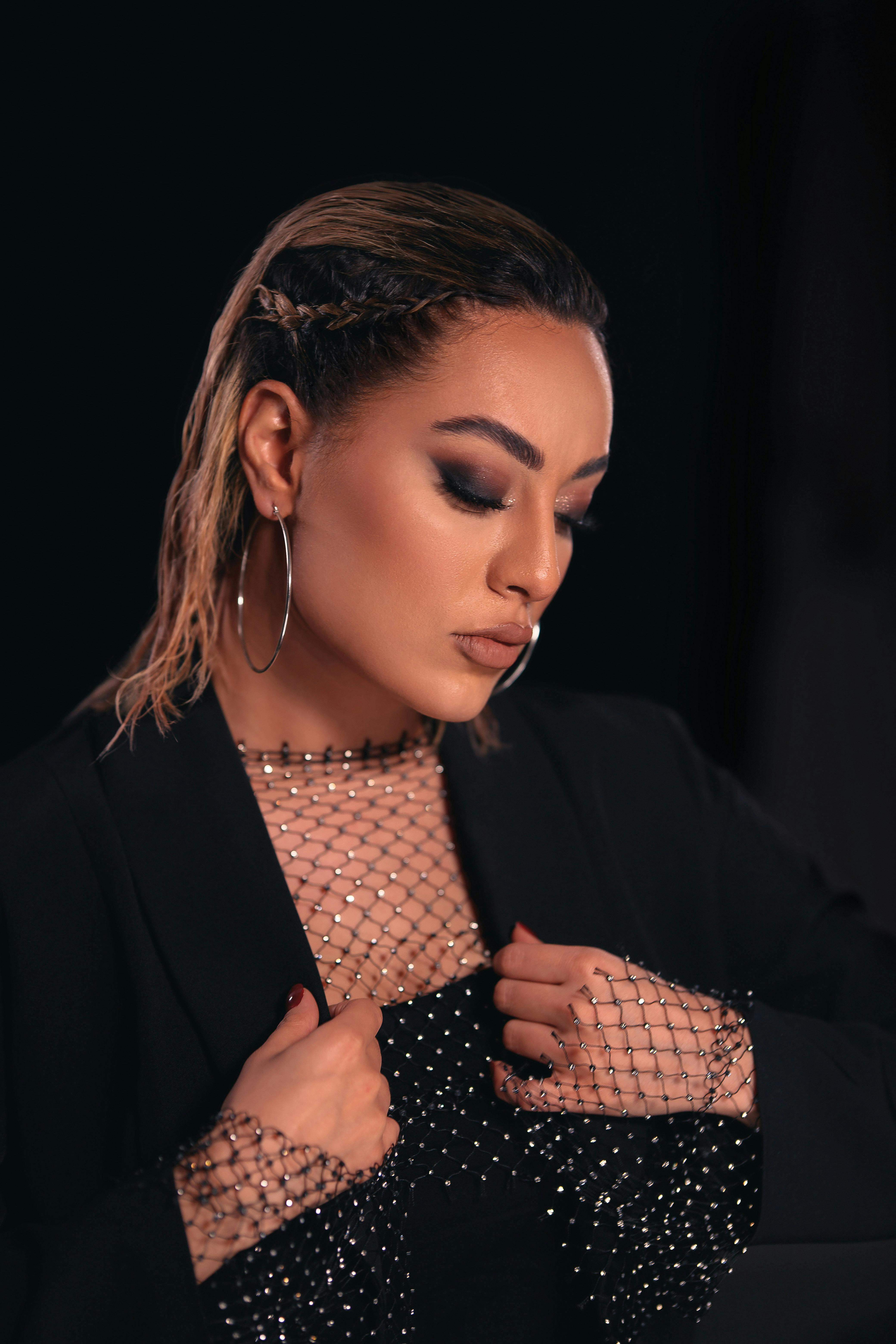 Portrait of a woman in a rhinestone mesh blouse, fashion photography.
