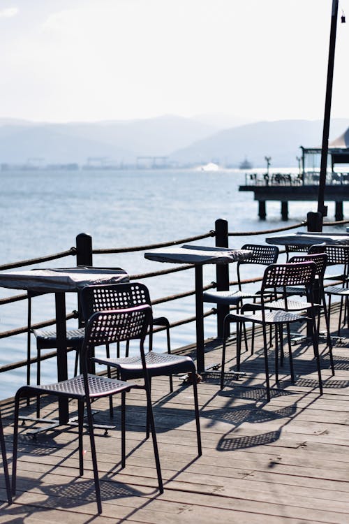 Tables and Chairs on Pier on Sea Shore