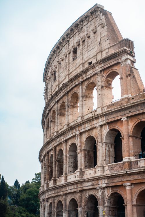 Free Beautiful view of the ancient Colosseum in Rome, capturing its architectural grandeur and historical significance. Stock Photo