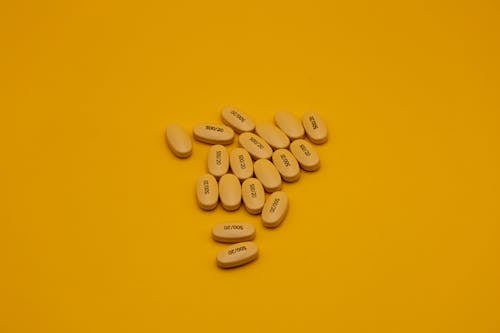 Yellow Pills on Yellow Background