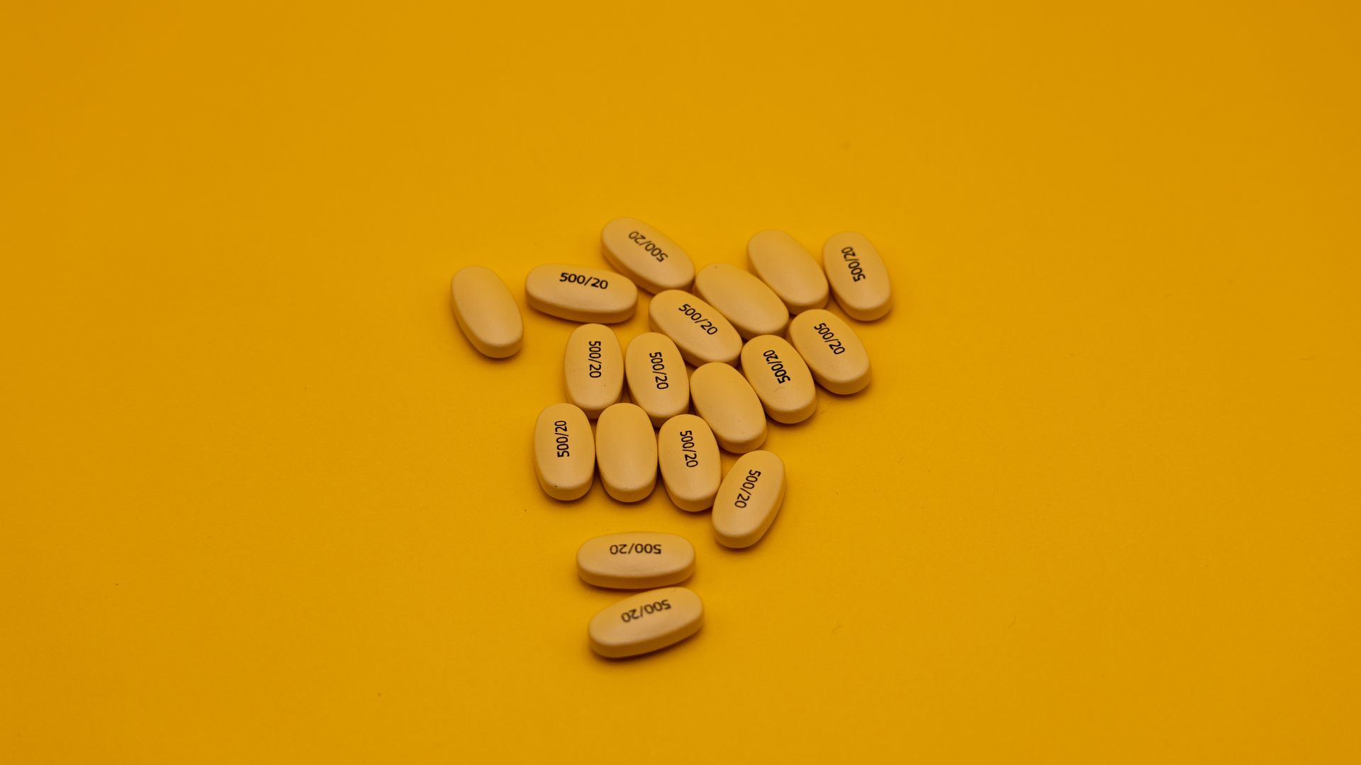 Best Modafinil Brand: Unlocking the Secrets of Smart Drugs A collection of yellow pills with labeling on a bright yellow background, ideal for healthcare themes.