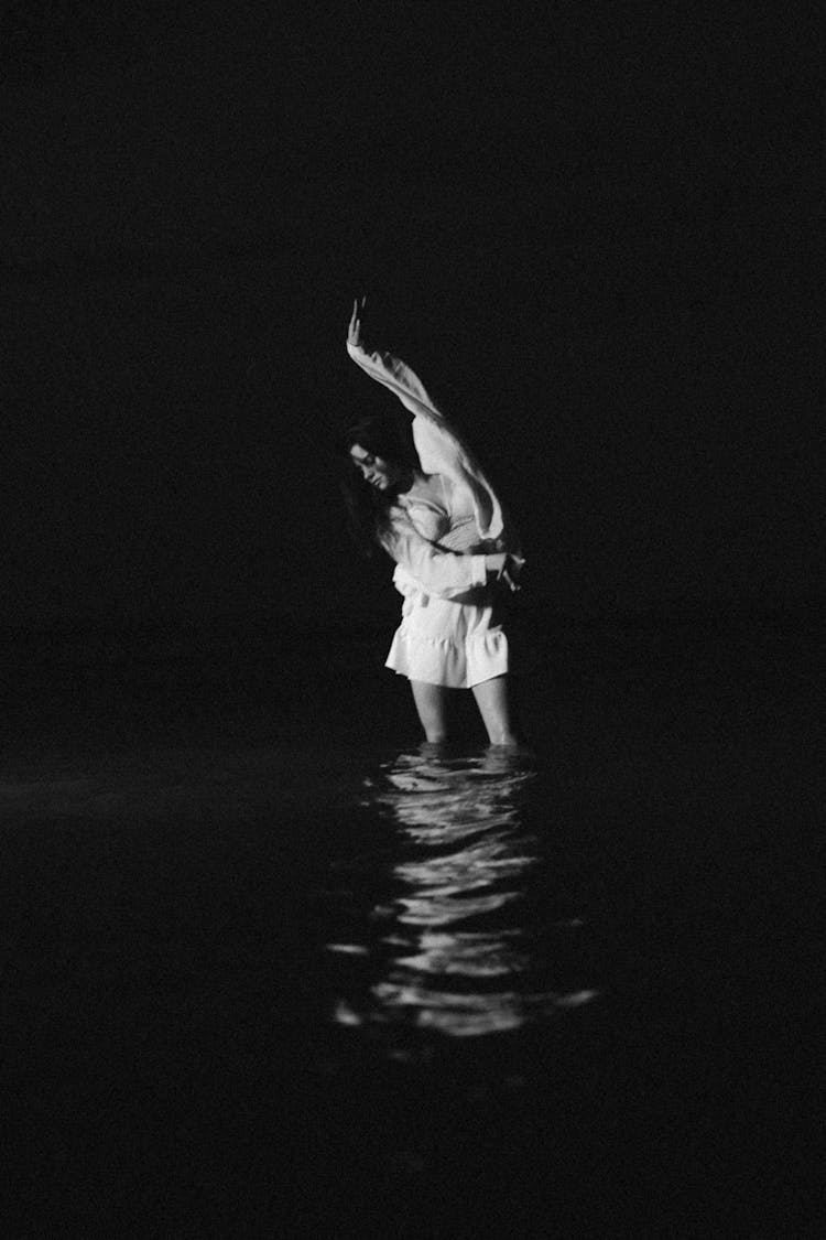 Woman Posing In Water At Night In Black And White