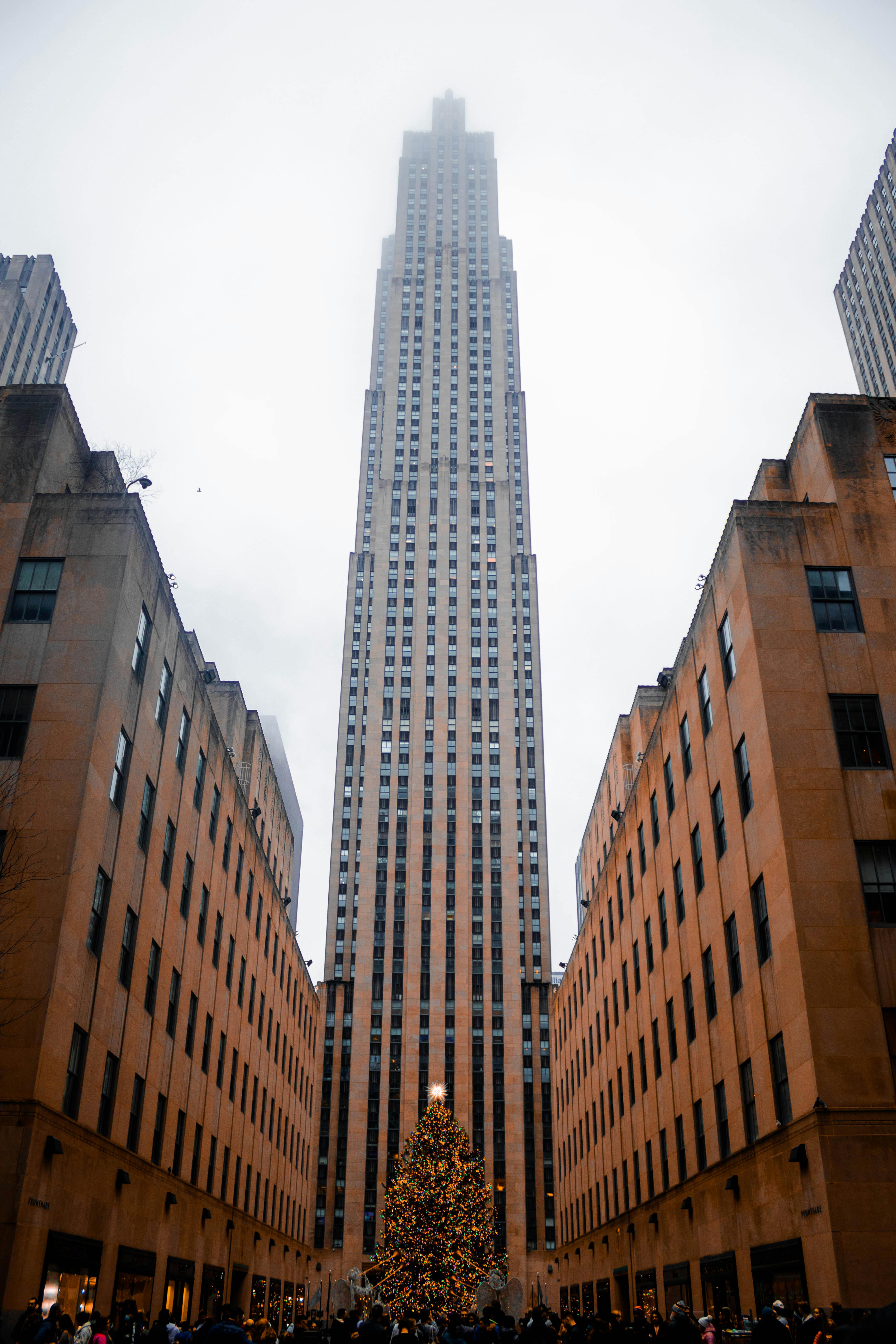 Rockefeller Center in New York with a towering Christmas tree, capturing holiday spirit and iconic architecture.