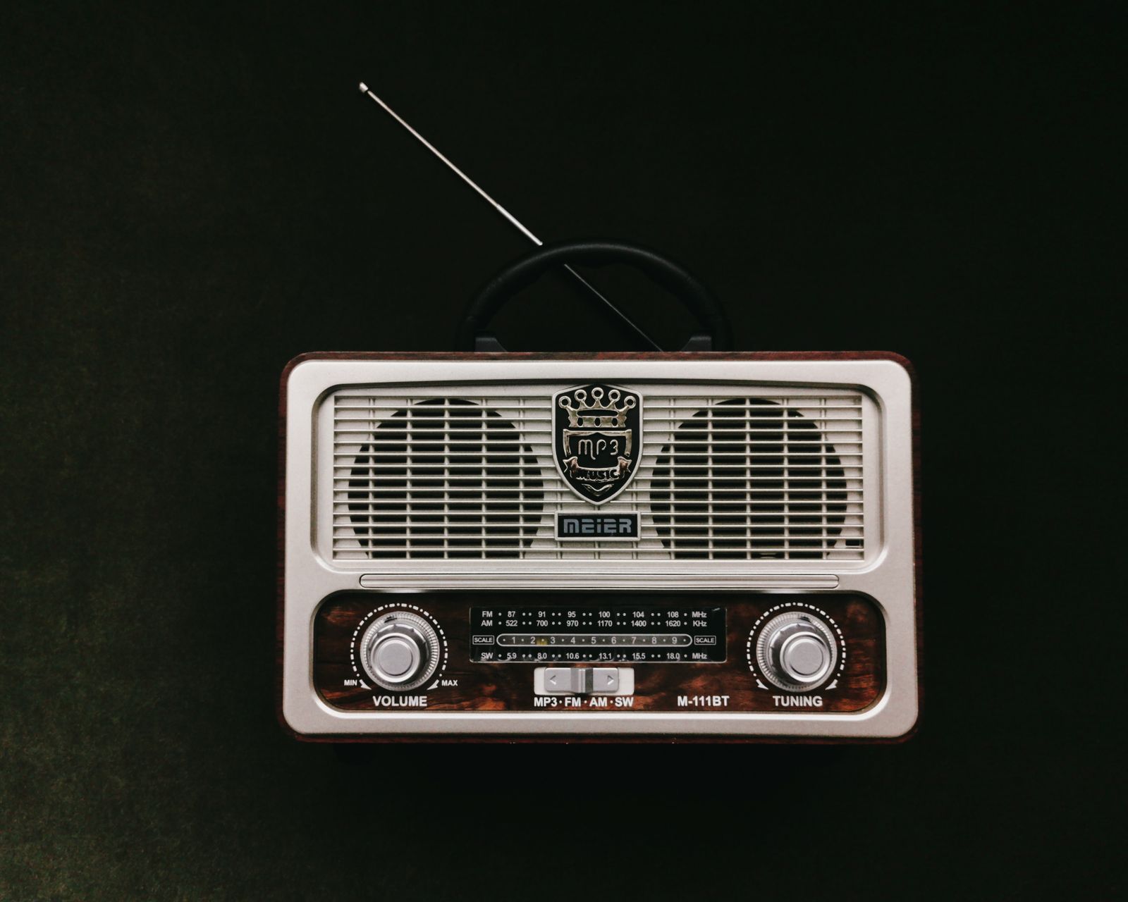 Vintage radio receiver with antenna on a dark background