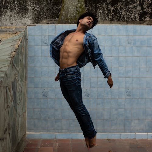 Jumping Model in Jeans and Denim Shirt
