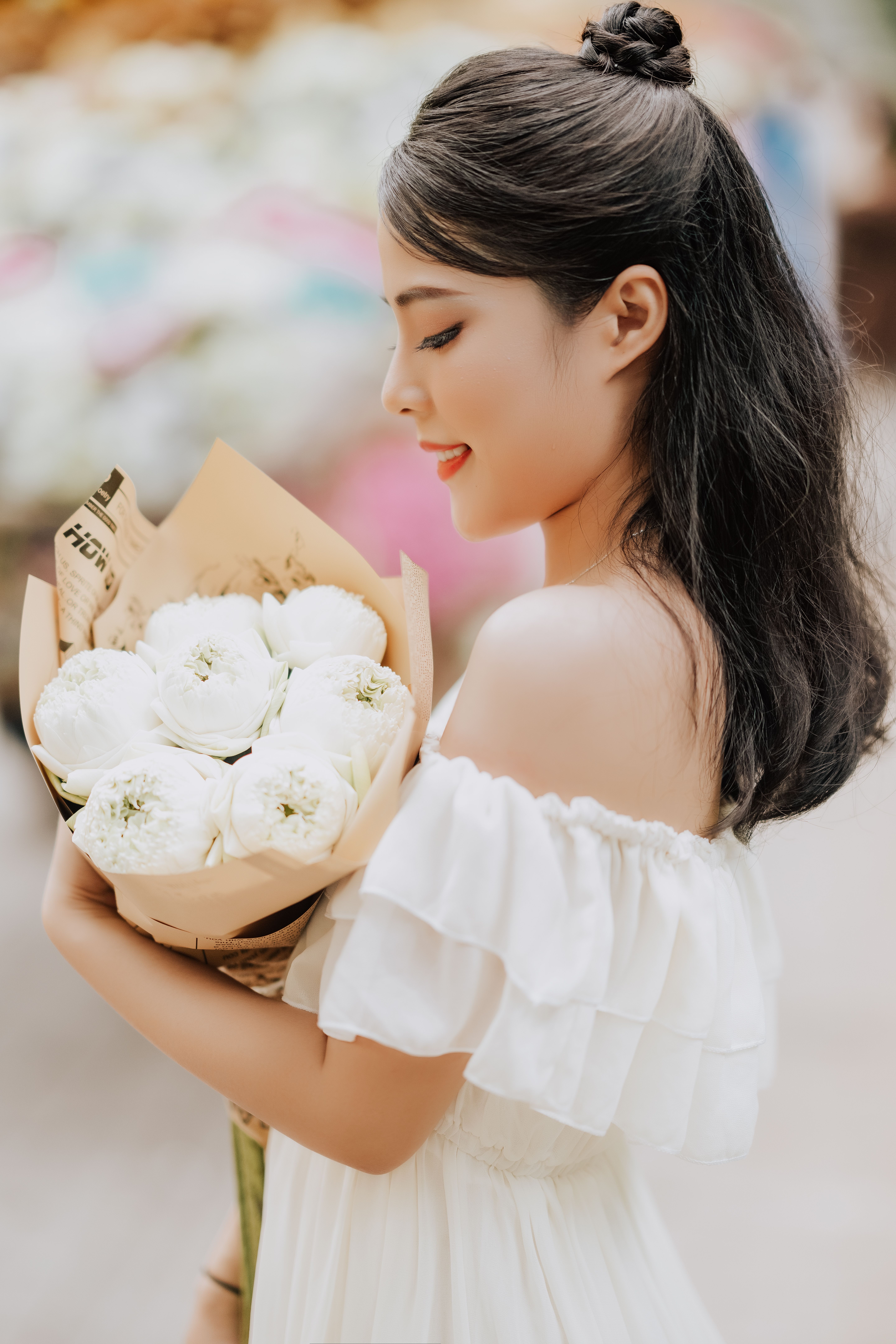 Woman Holding a Bouquet of White Flowers · Free Stock Photo