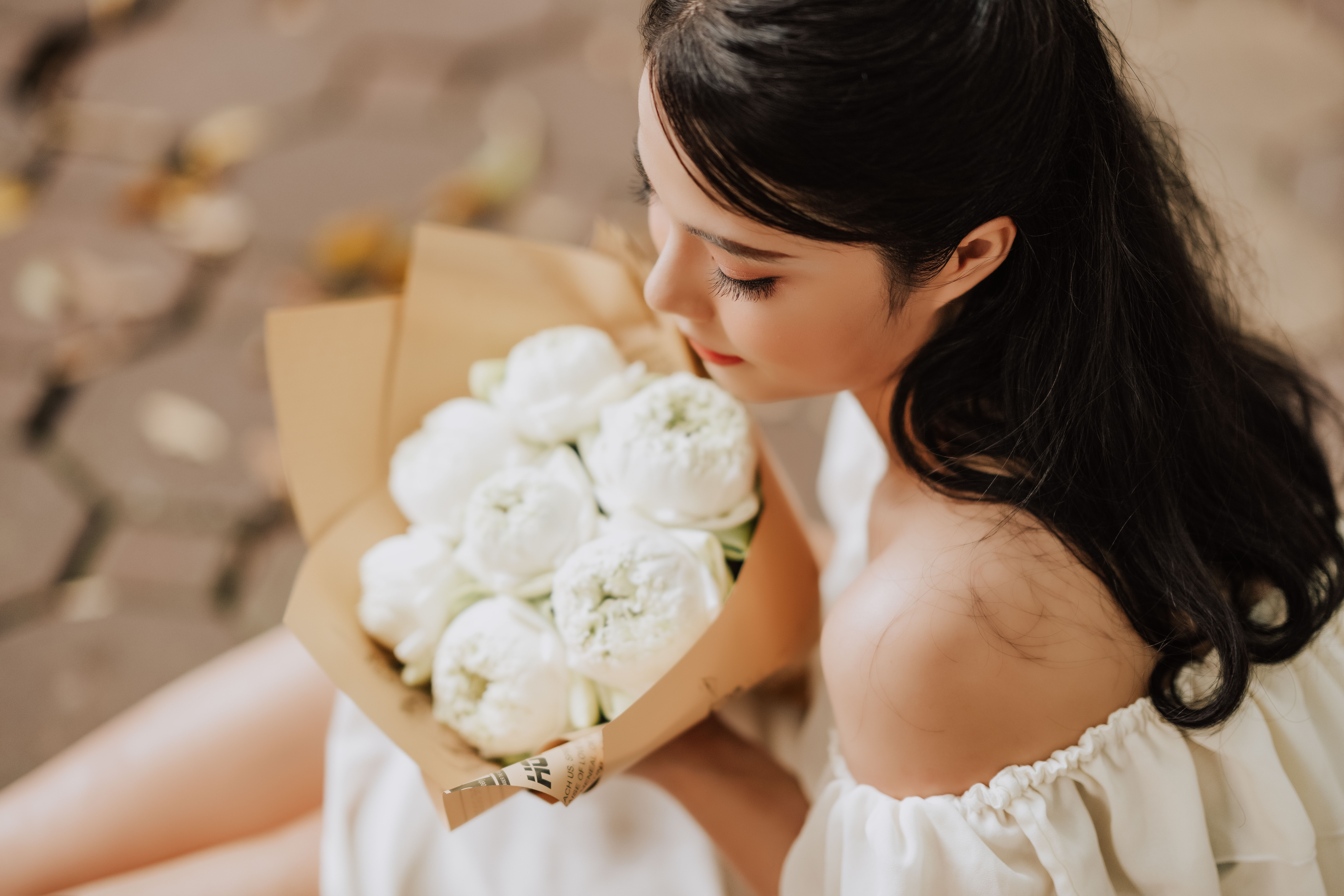 Young Woman in a White Dress Holding a Bouquet · Free Stock Photo