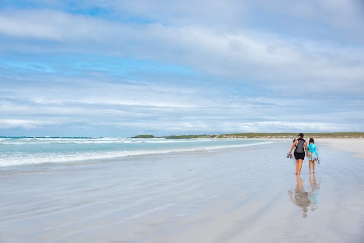 Couple Walking Along Beach