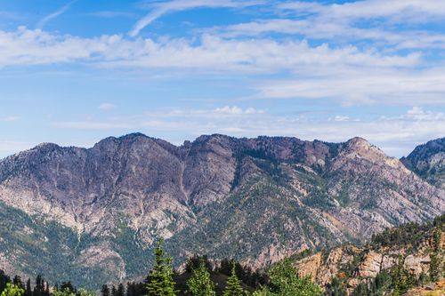 Free A stunning view of a mountain range with clear blue skies and lush greenery. Stock Photo