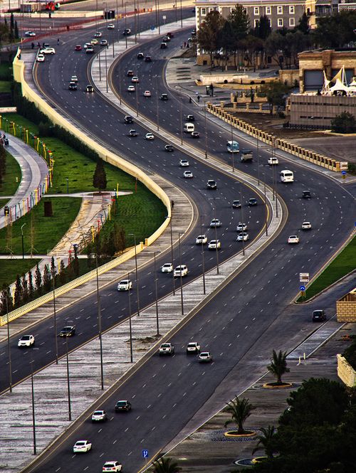 Free High-angle view of a busy winding highway in Baku, Azerbaijan showcasing traffic and urban landscape. Stock Photo