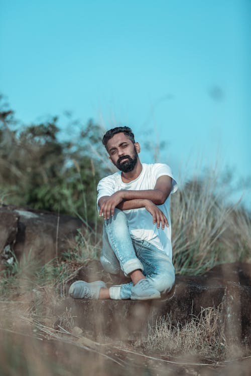 Man Sitting on Posing on Grassland