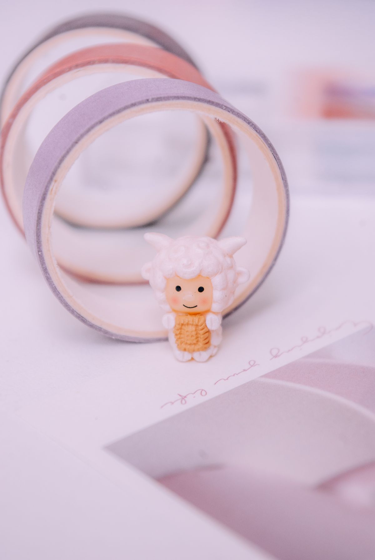 Sheep figurine among pastel crafting tapes used for lightweight duct tape earrings