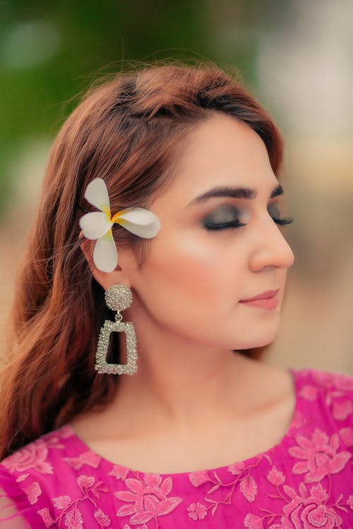 Woman with Luxury Earring and Flower in Hair