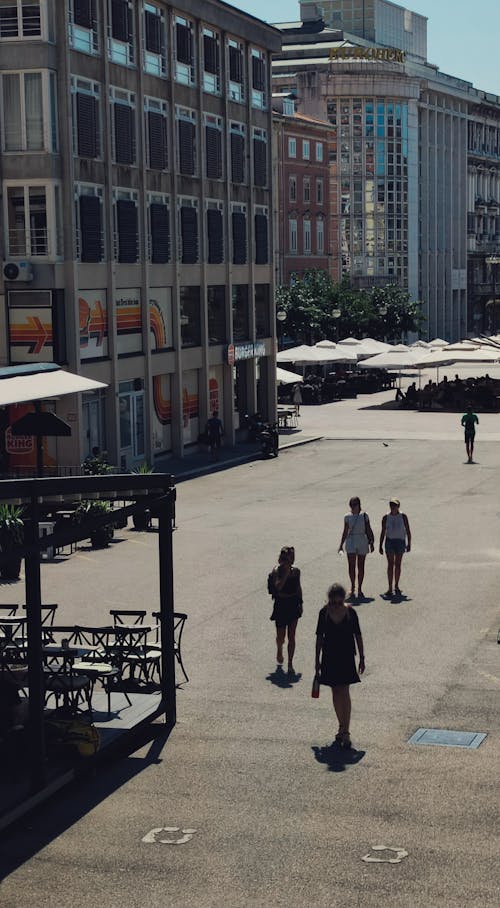 People Walking on a City Place in Summer