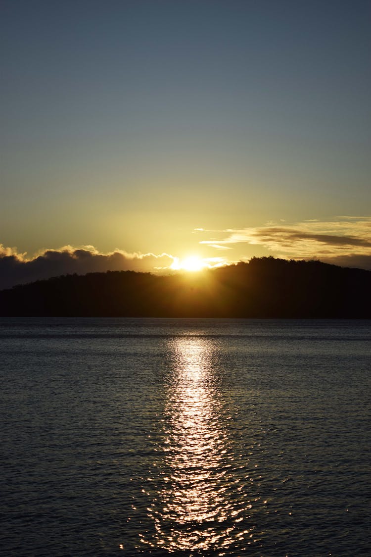 Morning Seascape With Sun Rising Over A Mountain