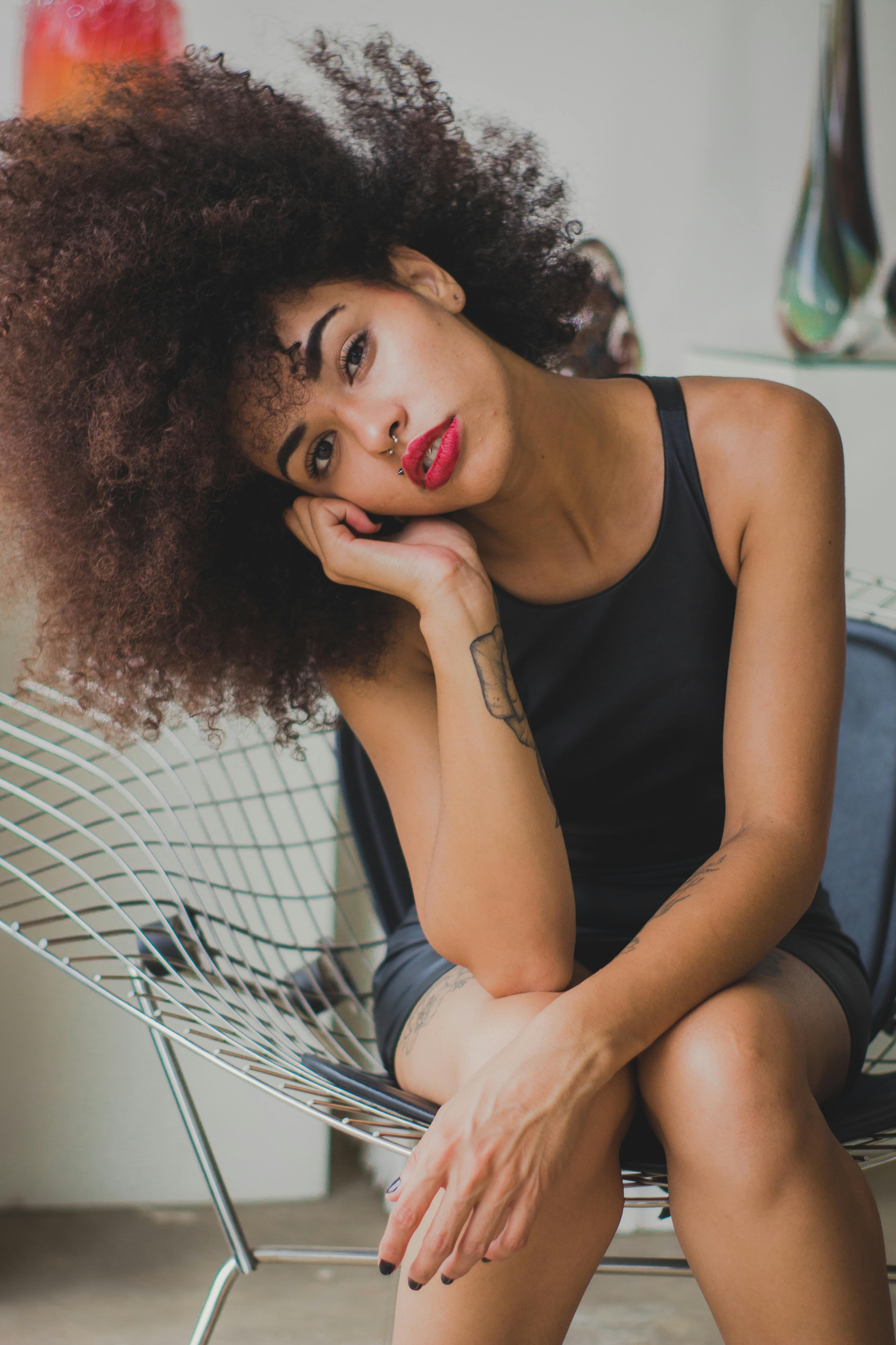 Woman Sitting On Chair While Leaning Face On Her Right Hand · Free Stock Photo