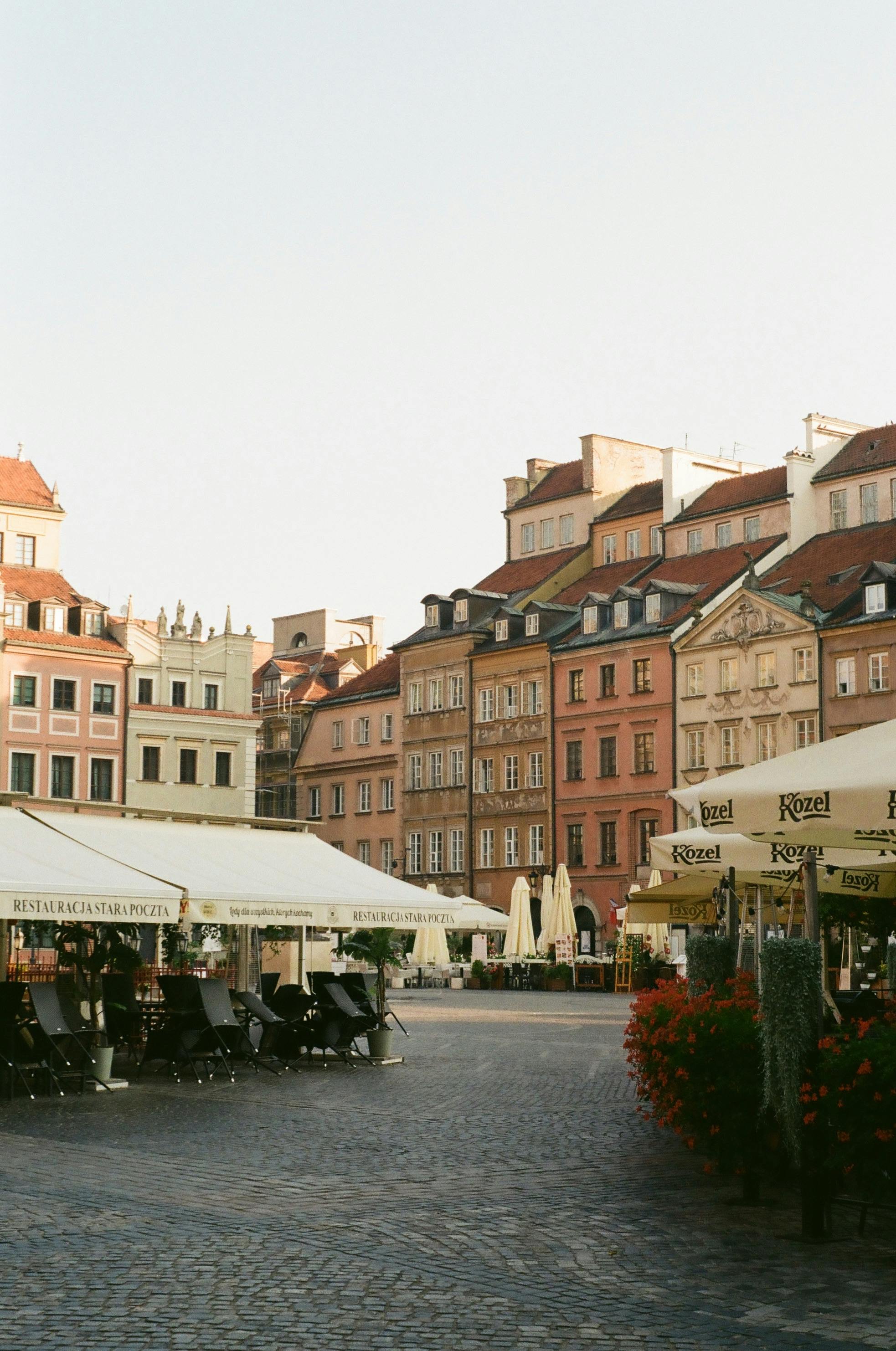 Explore the picturesque Warsaw Old Town with colorful buildings and cozy cafes in a vibrant urban setting.