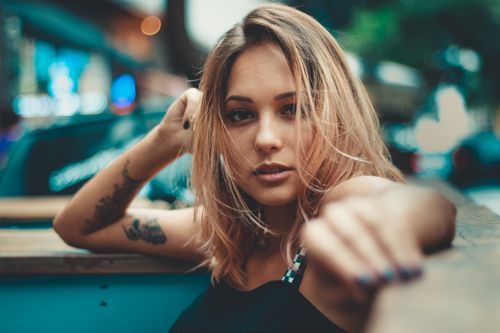 Free A stylish young woman with tattoos in an outdoor city setting. Stock Photo