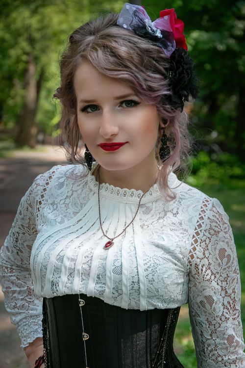 Free Portrait of a woman in vintage Victorian dress with lace details, outdoors. Stock Photo