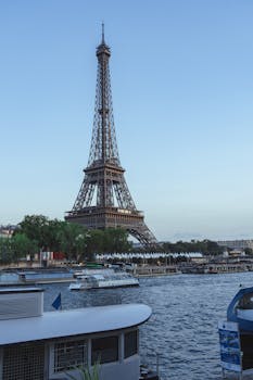 The iconic Eiffel Tower seen from the Seine River in Paris, captured on a clear day.