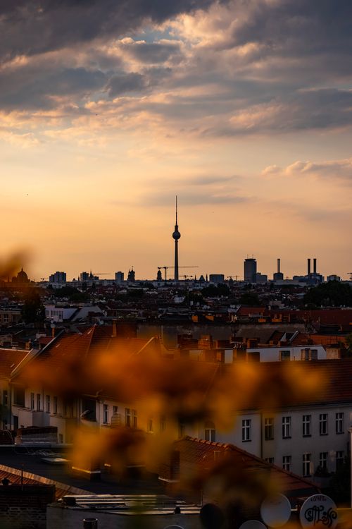 Free A breathtaking view of Berlin's skyline with the TV tower at sunset, capturing a warm urban cityscape. Stock Photo
