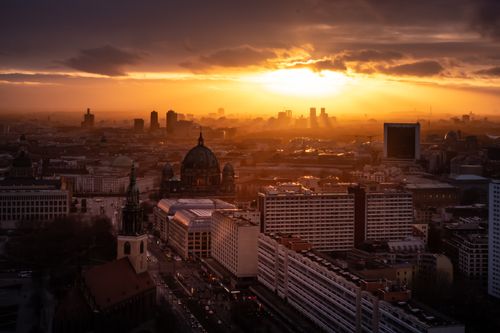 Free A stunning aerial view of a cityscape at sunset, highlighting urban architecture and dramatic skies. Stock Photo
