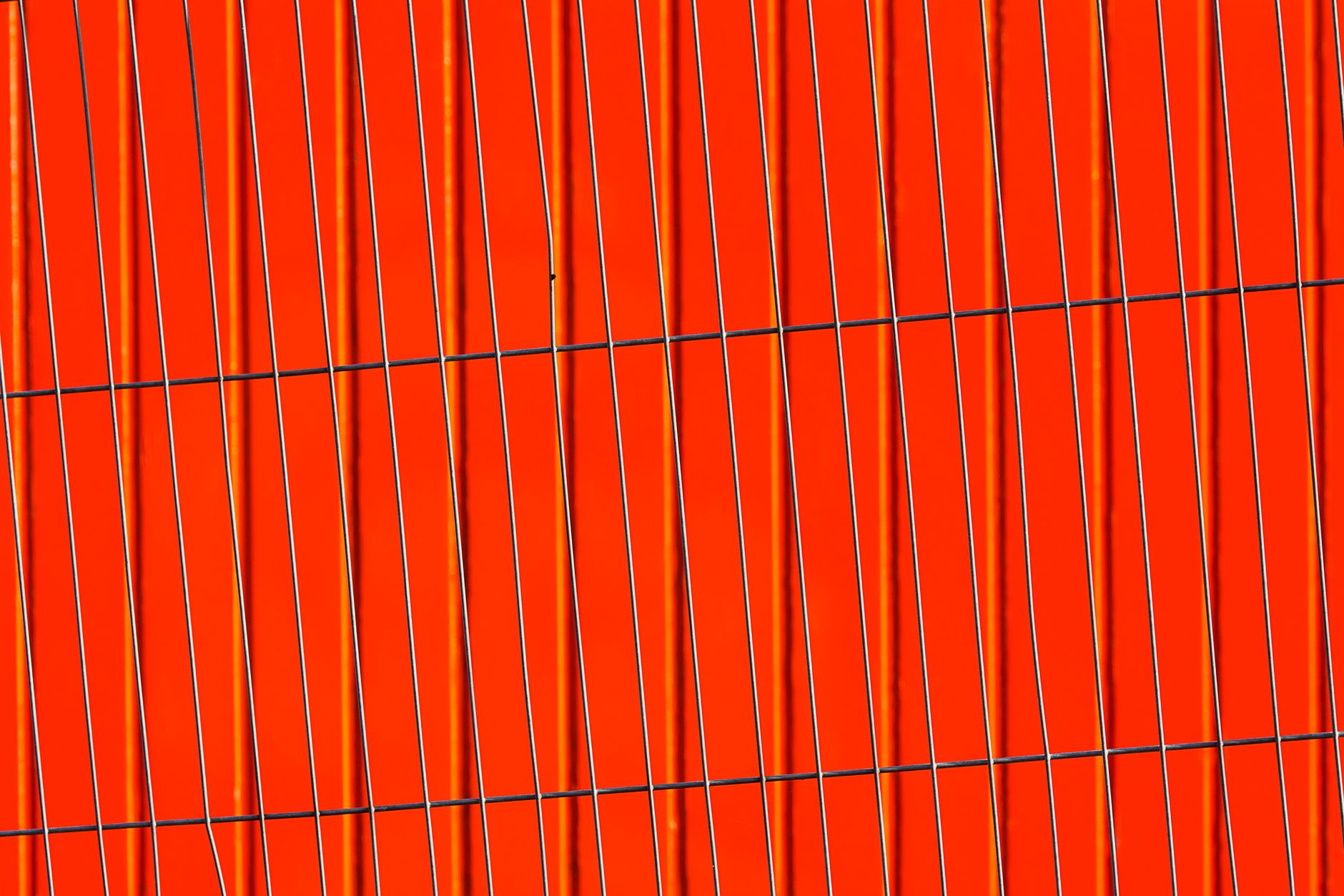 Modern abstract image featuring vertical lines against a bold red background.