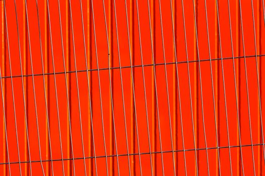 Modern abstract image featuring vertical lines against a bold red background.