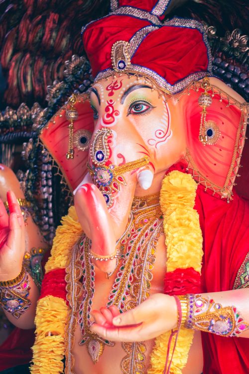 Free Colorful Ganesha idol adorned in traditional Indian decorations, symbolizing Hindu culture and spirituality. Stock Photo