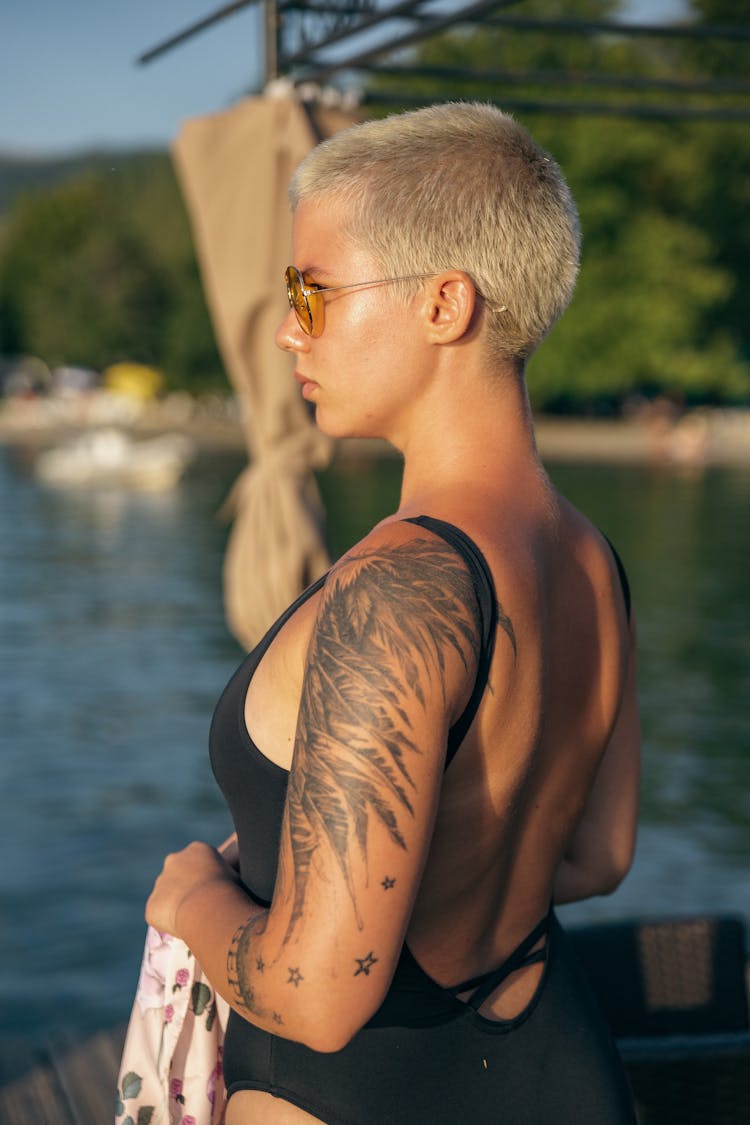 Woman With A Tattoo On A Beach