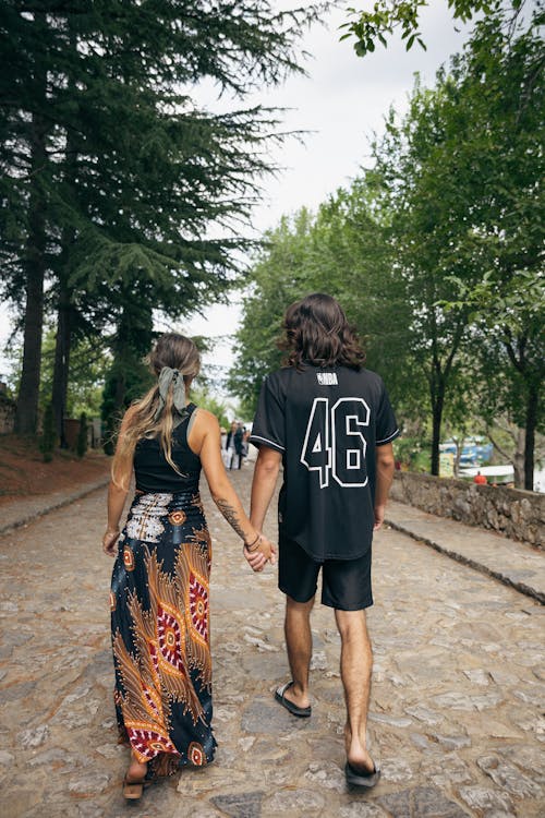 Couple Holding Hands and Walking Together