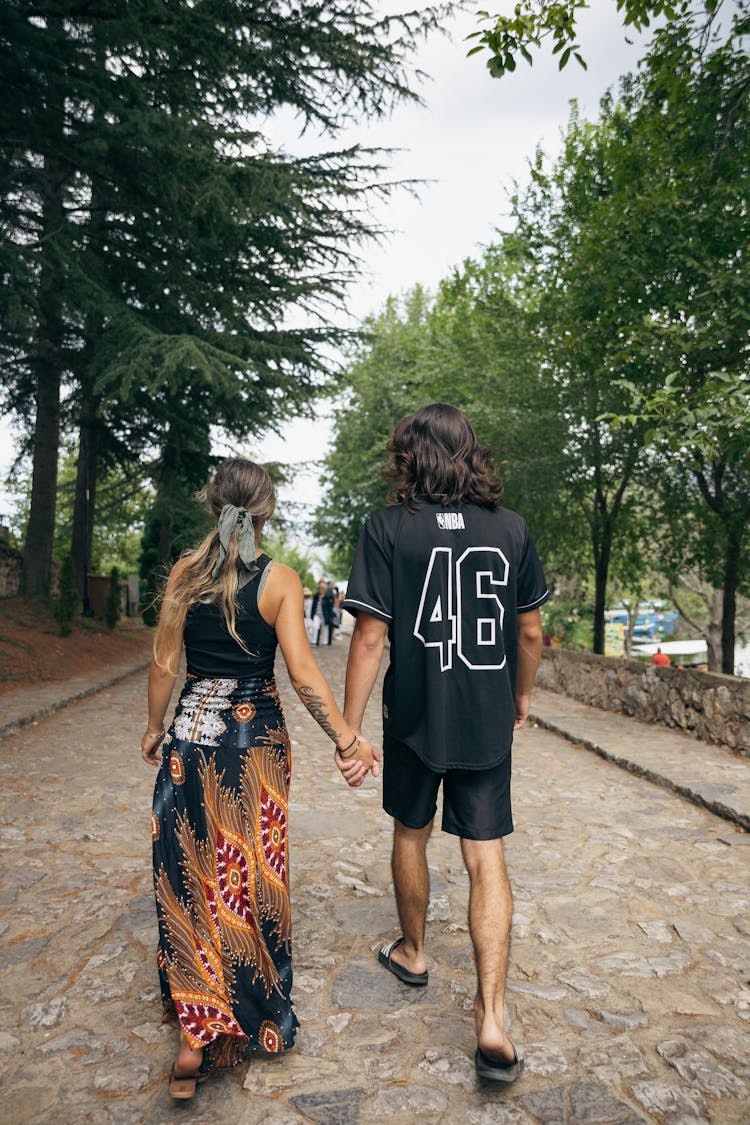 Couple Holding Hands And Walking Together