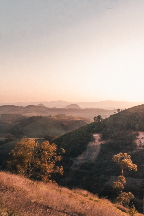 Free Breathtaking sunrise landscape with misty hills in Alto Rio Novo, Brazil, capturing the serene beauty of nature. Stock Photo
