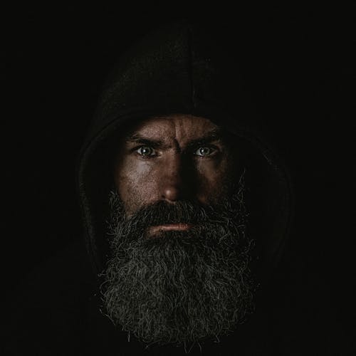 Face of Man with Beard in Darkness