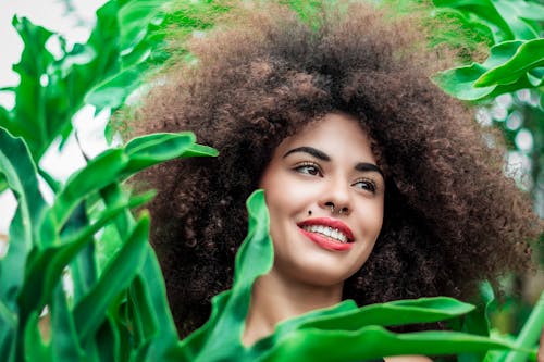 Free Smiling Woman Beside Green Leafed Plants Stock Photo