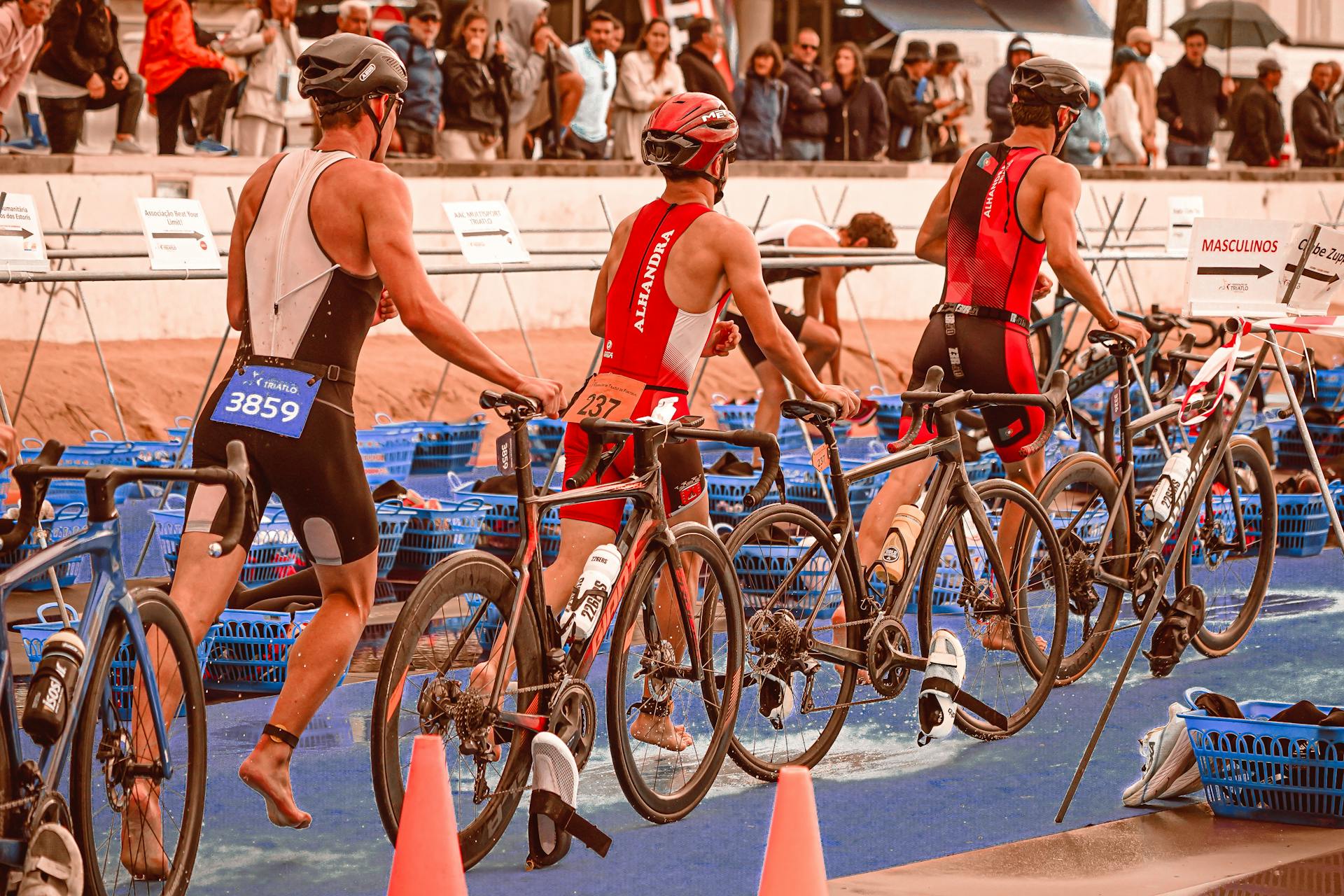 Athletes transition from swimming to cycling at a triathlon event.