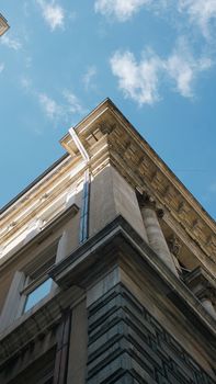 Upward shot of classic architectural building against a clear blue sky.