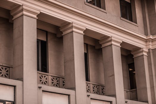 A detailed view of a classic building facade featuring pillars and windows.