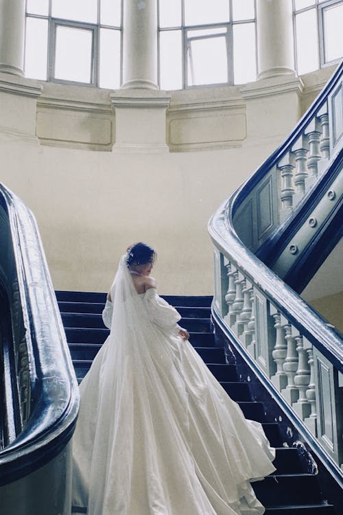 Bride in Wedding Dress Posing on Stairs