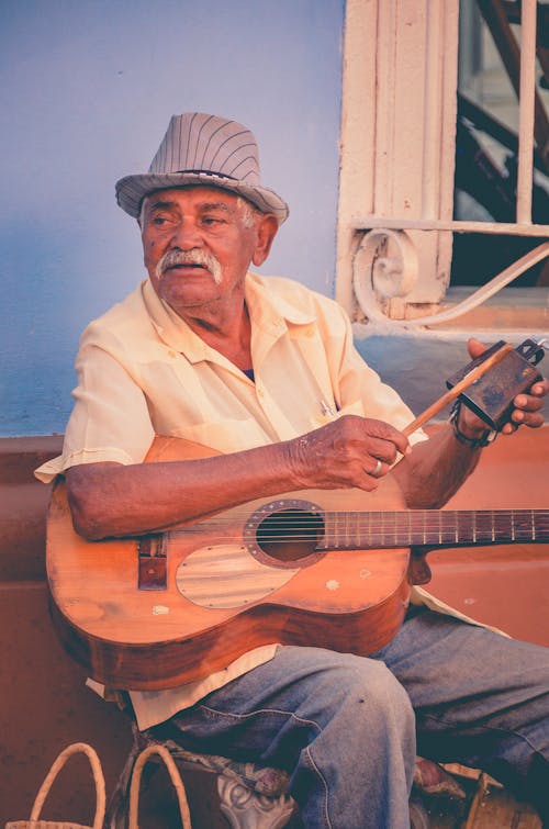 Man Sitting With Guitar