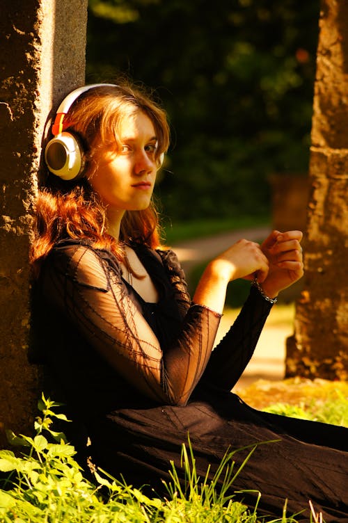 Woman in Black Clothes Sitting in Headphones
