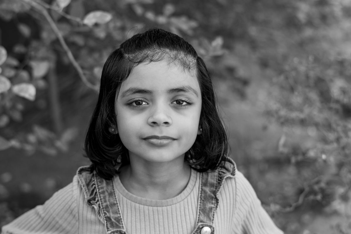 Black and White Portrait of a Smiling Girl Outdoors · Free Stock Photo