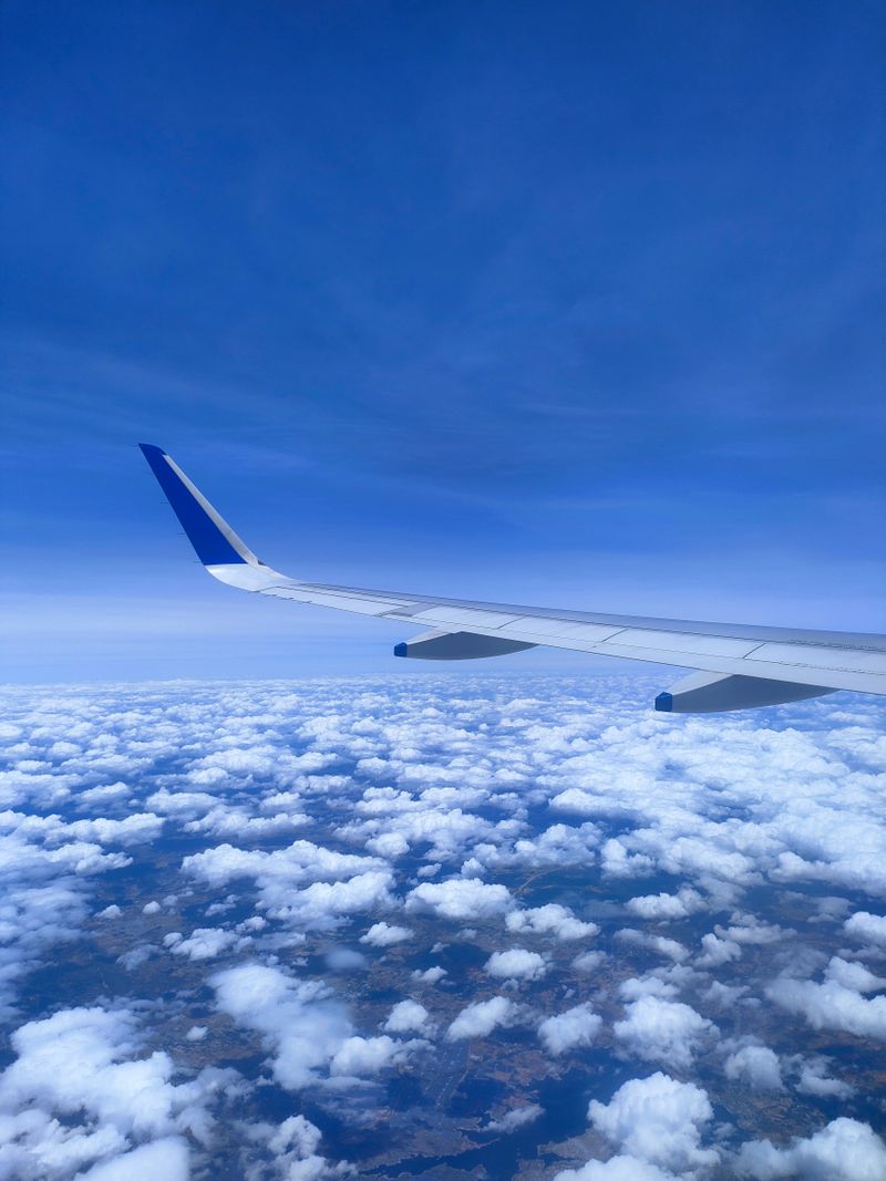 Airplane wing above the clouds on an international flight